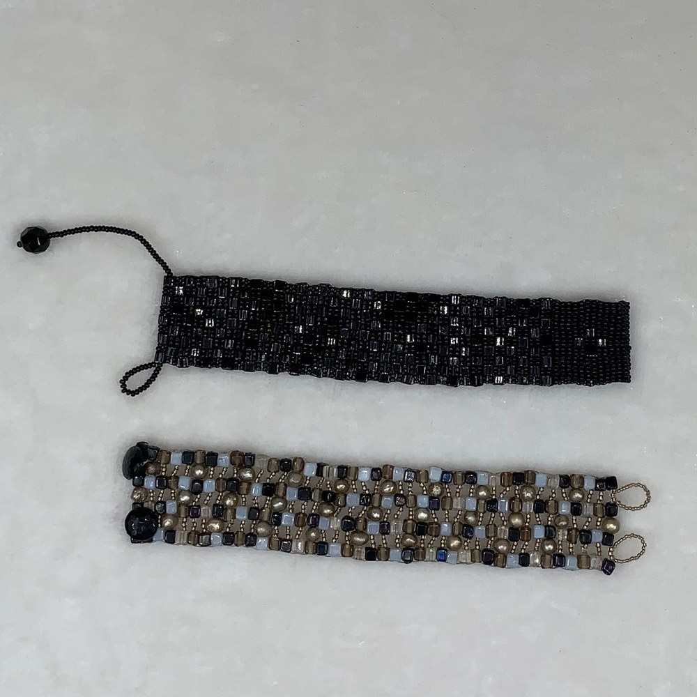 Two beaded bracelets with unique clasps.